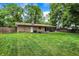 Large backyard with well-maintained lawn and stone exterior of the home; ready for relaxation or recreation at 741 Fairway Dr, Indianapolis, IN 46260