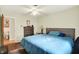 Comfortable bedroom connects to a bathroom featuring wood flooring, dresser and blue bedspread at 741 Fairway Dr, Indianapolis, IN 46260