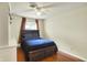 Comfortable bedroom with a wood framed bed, wood flooring and neutral paint at 741 Fairway Dr, Indianapolis, IN 46260