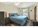 Bright bedroom with blue bedding, bedside table and a view to the outside at 741 Fairway Dr, Indianapolis, IN 46260