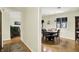 Charming dining room with modern pendant lighting, a large window, and an adjacent living space at 741 Fairway Dr, Indianapolis, IN 46260