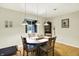 Cozy dining area with pendant lighting offers a view to the serene backyard at 741 Fairway Dr, Indianapolis, IN 46260