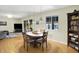 Open-concept dining room flows to living area, showcasing natural light, and a classic bookcase at 741 Fairway Dr, Indianapolis, IN 46260
