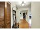 Bright entryway featuring a coat rack, closet with bifold doors, and wood floors that lead to the living space at 741 Fairway Dr, Indianapolis, IN 46260