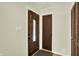 Inviting entryway with wood-grain doors and neutral walls, a light switch, and a closet with bifold doors at 741 Fairway Dr, Indianapolis, IN 46260