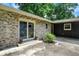Charming home exterior with stone facade, sliding glass doors, and mature landscaping at 741 Fairway Dr, Indianapolis, IN 46260