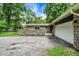 Home exterior highlighting stone accents, a well-maintained driveway, and an attached garage at 741 Fairway Dr, Indianapolis, IN 46260