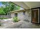Welcoming exterior featuring a stone facade, covered entry, and a well-manicured garden space at 741 Fairway Dr, Indianapolis, IN 46260