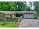 Lovely home showcasing a stone exterior, attached garage, and manicured front yard for curb appeal at 741 Fairway Dr, Indianapolis, IN 46260