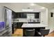 Updated kitchen features stainless steel appliances, center island with seating, and granite countertops at 741 Fairway Dr, Indianapolis, IN 46260