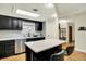 Modern kitchen features stainless steel appliances, light-filled skylight, and center island with seating at 741 Fairway Dr, Indianapolis, IN 46260