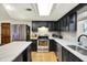 This updated kitchen features granite counters, stainless appliances, dark wood cabinets, and a bright skylight at 741 Fairway Dr, Indianapolis, IN 46260