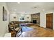 Cozy living room features a stone fireplace, wood floors, comfortable seating, and natural light at 741 Fairway Dr, Indianapolis, IN 46260
