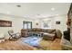 Comfortable living room featuring a large sectional sofa, wood floors, fireplace, and sliding glass doors to the exterior at 741 Fairway Dr, Indianapolis, IN 46260