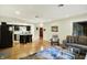 Open concept living room leads to the kitchen, featuring wood floors, comfortable seating, and modern décor at 741 Fairway Dr, Indianapolis, IN 46260