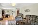 Open-concept layout showcases living room with seating, an area rug, and connection to dining area at 741 Fairway Dr, Indianapolis, IN 46260