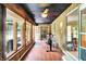 Bright sunroom with wood paneled walls, lots of windows and an exercise machine at 741 Fairway Dr, Indianapolis, IN 46260
