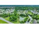 Aerial view of a community featuring ponds, tree-lined streets, and diverse housing styles at 7521 Kilbarron Cir, Indianapolis, IN 46217