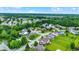 Overhead view of neighborhood with lush landscaping, pond, and houses with well-manicured lawns at 7521 Kilbarron Cir, Indianapolis, IN 46217