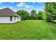 Vast backyard with manicured lawn and mature trees, offering a serene and private outdoor space at 7521 Kilbarron Cir, Indianapolis, IN 46217