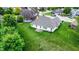Aerial view of the backyard showcasing an expansive lawn and a patio sitting area at 7521 Kilbarron Cir, Indianapolis, IN 46217