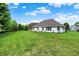 Large, grassy backyard with a patio area, perfect for entertaining guests and enjoying the outdoors at 7521 Kilbarron Cir, Indianapolis, IN 46217