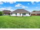 Expansive backyard featuring a well-manicured lawn and a charming patio seating area at 7521 Kilbarron Cir, Indianapolis, IN 46217