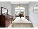Dining room features a long table with chandelier lighting and a large bright window at 7521 Kilbarron Cir, Indianapolis, IN 46217