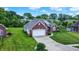 Charming brick home with a spacious driveway, a two-car garage, and a beautifully landscaped front yard at 7521 Kilbarron Cir, Indianapolis, IN 46217