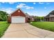 Charming single-story red brick home featuring an attached two-car garage and well-maintained lawn at 7521 Kilbarron Cir, Indianapolis, IN 46217