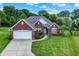 Beautiful brick home with a two-car garage, landscaped front yard, and well-maintained lawn at 7521 Kilbarron Cir, Indianapolis, IN 46217