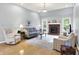 Bright and airy living room with hardwood floors, fireplace, neutral paint, and comfortable seating arrangement at 7521 Kilbarron Cir, Indianapolis, IN 46217