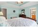Bright bedroom with tray ceiling, view into the ensuite bathroom, and comfortable furniture at 7521 Kilbarron Cir, Indianapolis, IN 46217