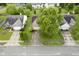 Aerial view of a home featuring well-manicured lawns, mature trees, and a spacious driveway at 7724 Blackthorn Dr, Indianapolis, IN 46236
