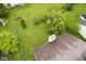 Aerial view of a green backyard with mature trees, well-kept lawn, and an enclosed fence at 7724 Blackthorn Dr, Indianapolis, IN 46236