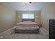 Bedroom with a queen bed, plush carpet, and neutral wall color at 7724 Blackthorn Dr, Indianapolis, IN 46236