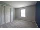 Bedroom with neutral walls, window, and gray carpet at 7724 Blackthorn Dr, Indianapolis, IN 46236
