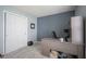 Bedroom with a gray accent wall, desk, and gray carpet at 7724 Blackthorn Dr, Indianapolis, IN 46236