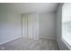 Bedroom with neutral walls, window, and gray carpet at 7724 Blackthorn Dr, Indianapolis, IN 46236