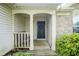 Inviting front porch with seating area and lush landscaping at 7724 Blackthorn Dr, Indianapolis, IN 46236