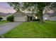 Charming brick home featuring a well-maintained lawn and mature tree, enhancing its curb appeal at 7724 Blackthorn Dr, Indianapolis, IN 46236