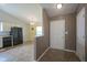 Bright entryway leads to a kitchen featuring a black refrigerator and spacious dining area at 7724 Blackthorn Dr, Indianapolis, IN 46236