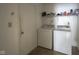 Functional laundry area with washer, dryer and utility shelving at 7724 Blackthorn Dr, Indianapolis, IN 46236