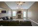 Comfortable living room with fireplace, tv and wood-look floors at 7724 Blackthorn Dr, Indianapolis, IN 46236
