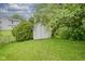 Charming backyard shed surrounded by lush greenery, providing practical storage with rustic appeal at 7724 Blackthorn Dr, Indianapolis, IN 46236