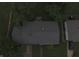 Bird's-eye view of the house shows the roof and surroundings with greenery and a car in the driveway at 7929 Roy Rd, Indianapolis, IN 46219