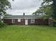 The backyard of the home has a table and chairs outside of the back door, and brick exterior walls at 7929 Roy Rd, Indianapolis, IN 46219