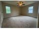 Spacious bedroom featuring carpet, fan lighting, and a window offering natural light at 7929 Roy Rd, Indianapolis, IN 46219