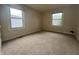 Spacious bedroom with two windows and neutral carpet at 7929 Roy Rd, Indianapolis, IN 46219