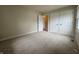 Bedroom featuring two windows, neutral carpet, and closet doors at 7929 Roy Rd, Indianapolis, IN 46219